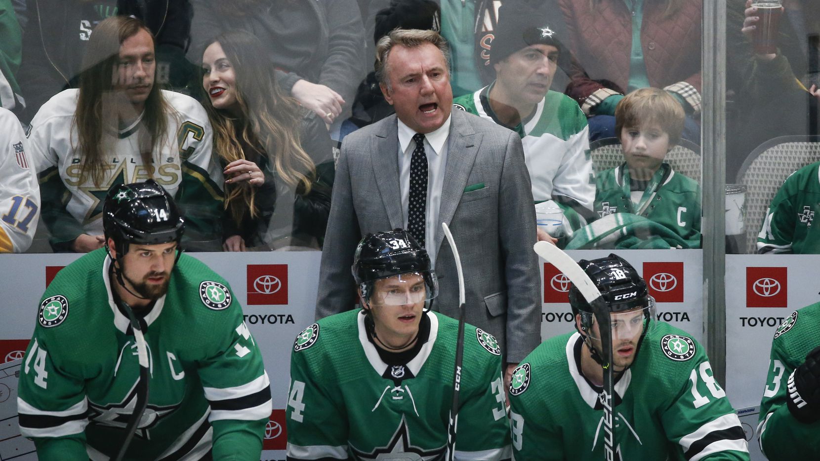 Dallas Stars interim head coach Rick Bowness works the bench during the first period of a...