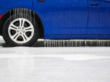 Icicles hang from a car in the parking lot of Terminal C at DFW Airport on Wednesday, Feb....
