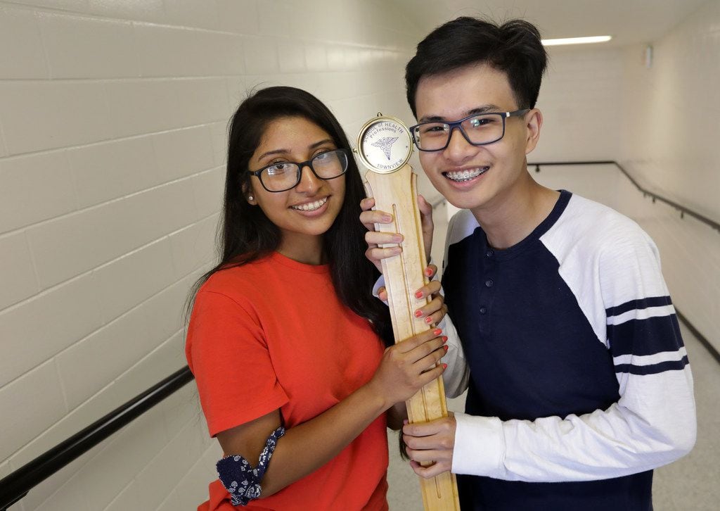 Fatima Roque, left, and Tri Truong pose with the ceremonial mace during rehearsal for their Townview Cemter School of Health Professions graduation at the Alfred J. Loos Sports Complex in Addison, TX, on May 30, 2019.The two 17-year-old students were both named valedictorian of their class, a first for Dallas ISD in at least 20 years. (Jason Janik/Special Contributor)