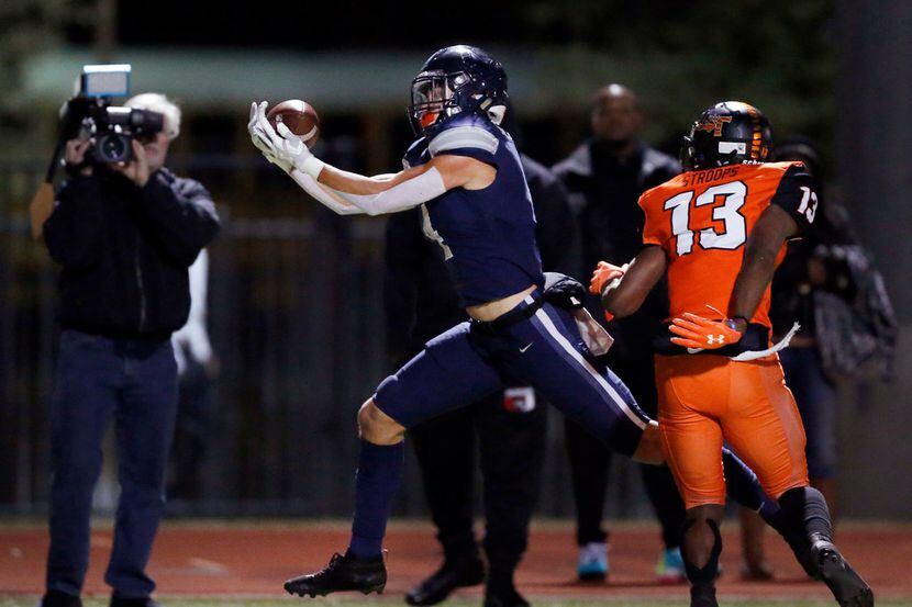 Frisco Lone Star wide receiver Trace Bruckler (4) hauls in a first quarter touchdown pass...