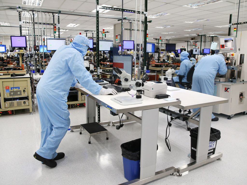 Employees work inside a manufacturing lab at Finisar in Allen. The company manufactures...