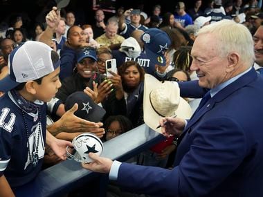 Dallas Cowboys owner and general manager Jerry Jones signs autographs for fans before an NFL football game against the Atlanta Falcons at AT&T Stadium on Sunday, Nov. 14, 2021, in Arlington.