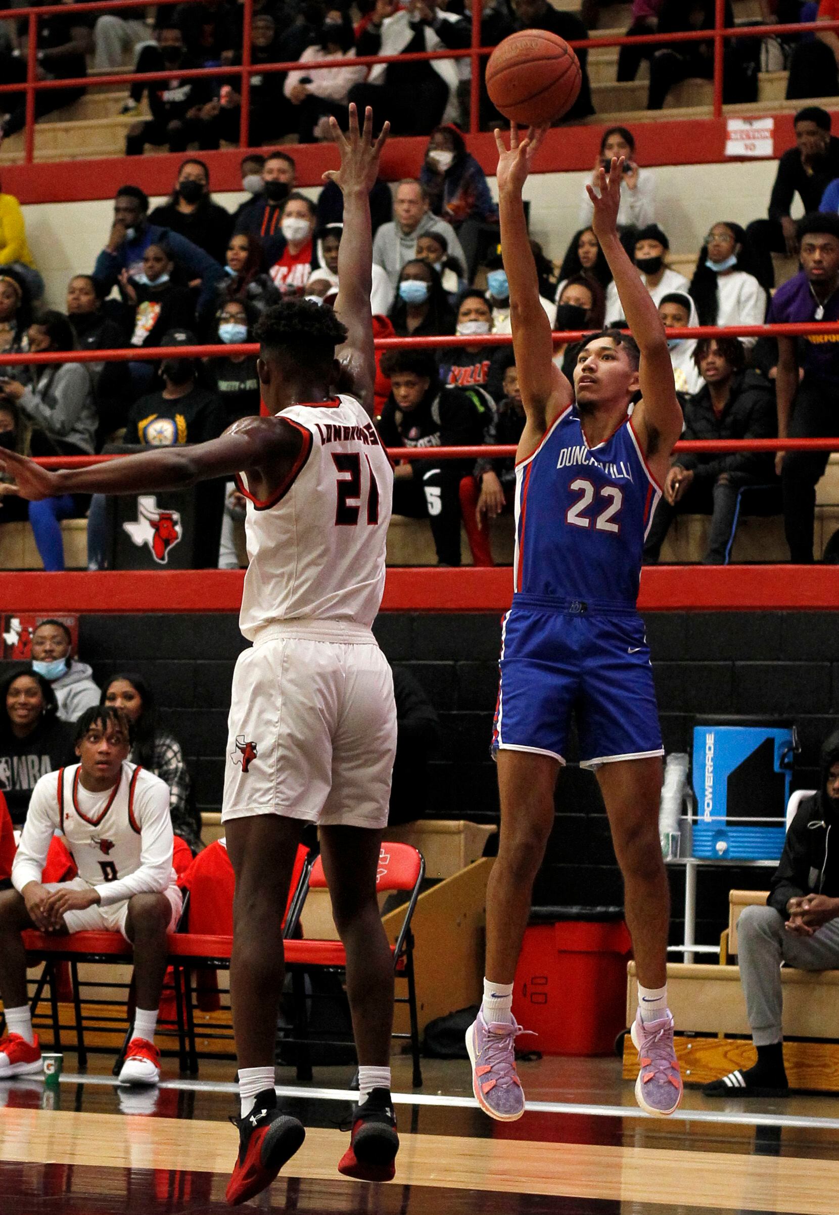 Duncanville guard Davion Sykes (22) shoots a jump shot over the defense of Cedar Hill defender Jeremy Watkins (21) during first half action. The two teams played their District 11-6A boys basketball game at Cedar Hill High School in Cedar Hill on January 14, 2022. (Steve Hamm/ Special Contributor)