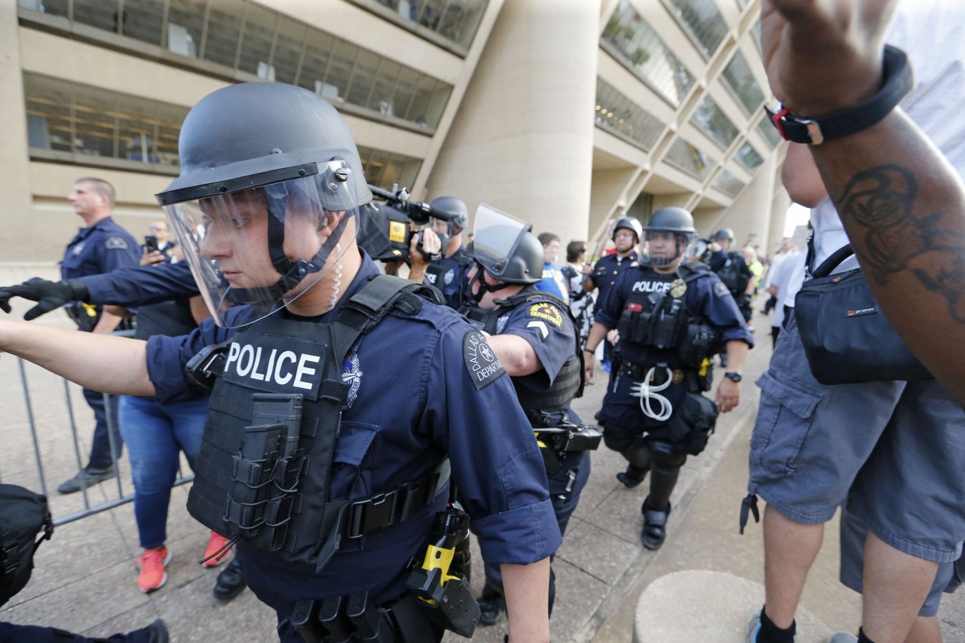 Dallas Police move into place during the March Against White Supremacy at Dallas City Hall.