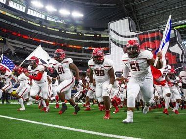 The Cedar Hill varsity team rushes onto the field before the Class 6A Division II area-round high school football playoff game at the AT&T Stadium in Arlington, Texas, on Saturday, November 23, 2019. (Lynda M. Gonzalez/The Dallas Morning News)