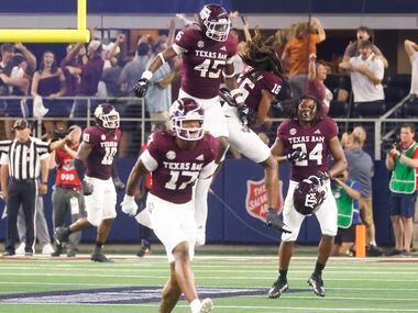 Texas A&M players celebrate as Arkansas misses to score during the second half of a football...