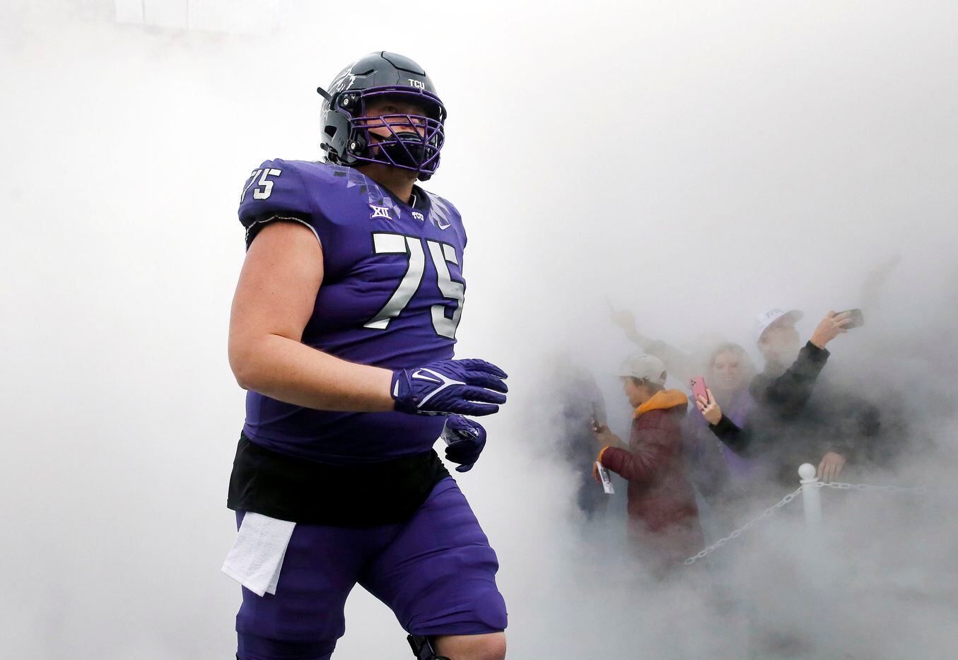 TCU Horned Frogs center Brannon Brown (75) takes the field in fog as the team faces Iowa...
