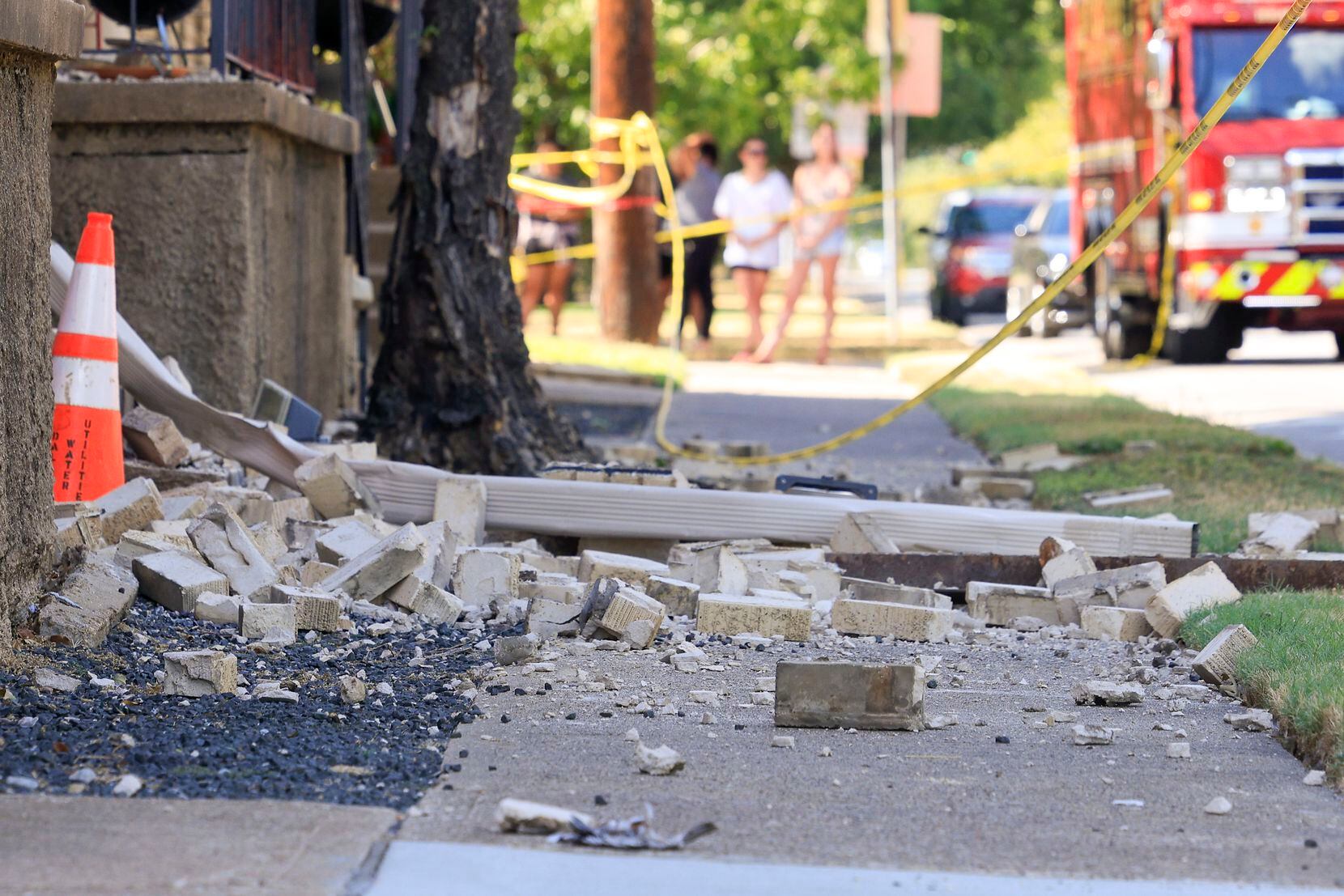 Brick and other debris covered a sidewalk outside the Marquita Court apartment building in...