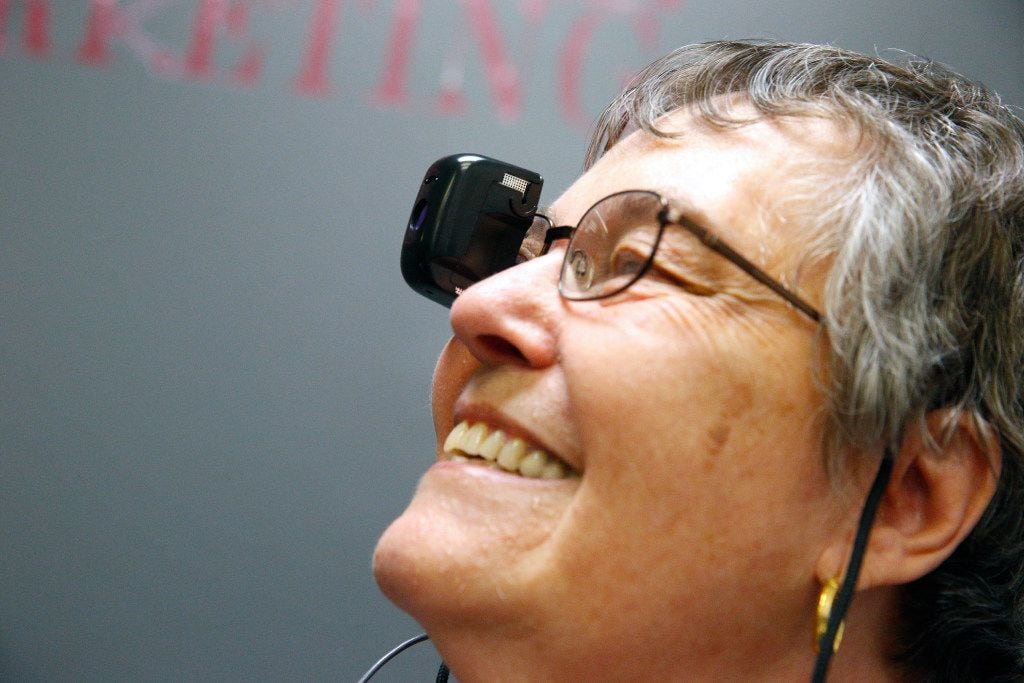 Ana Russo wears a seeBOOST, a camera that allows her to see far distances, in the call center at Bold Sales Solutions, a subsidiary of Dallas Lighthouse for the Blind.