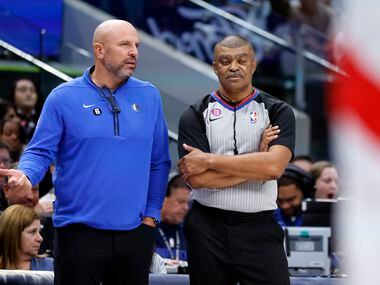 Dallas Mavericks head coach Jason Kidd (left) tries together a foul explanation from referee...
