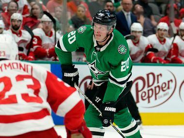 Detroit Red Wings right wing Lucas Raymond (23) looks on as Dallas Stars defenseman Ryan Suter (20) takes a shot and scores on the play in the first period of an NHL hockey game in Dallas, Tuesday, Nov. 16, 2021.