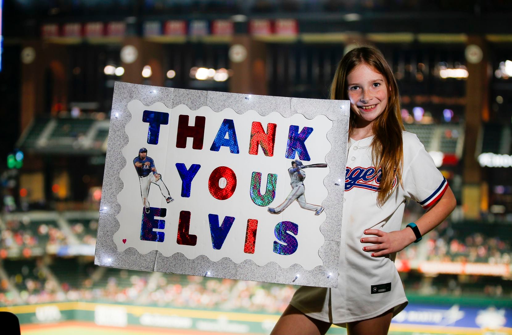 Emma Briceno, 10, a Elvis Andrus fan, poses for a photo during a baseball game between the...