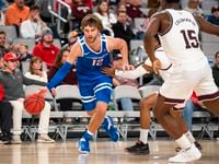 Boise State guard Max Rice (12) drives to the basket as Texas A&M's Wade Taylor IV and Henry...