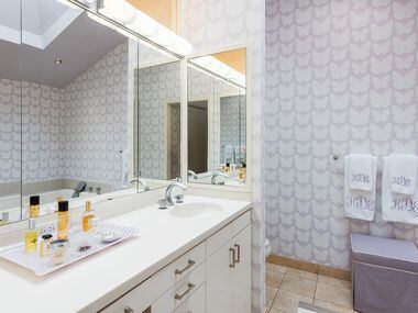 Bathroom with colorful, printed wallpaper at 5845 Lupton Drive.