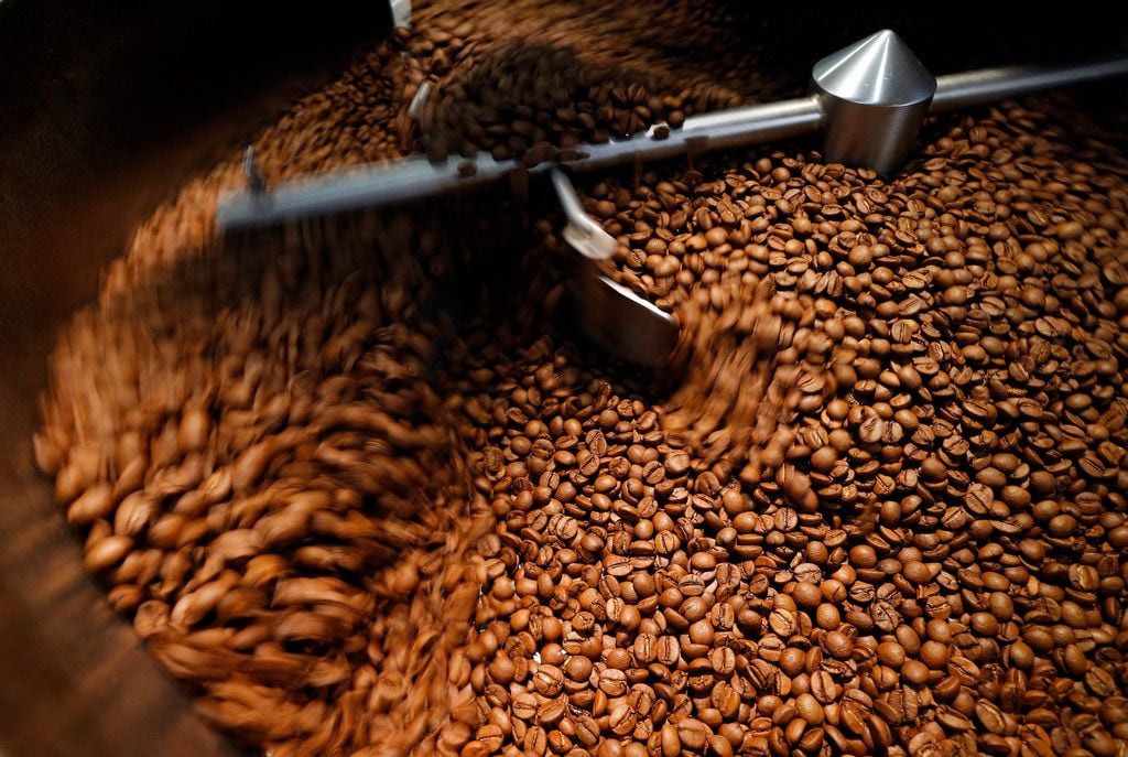 Roasted coffee beans rotate in a cooling bin at Ascension Coffee's headquarters in Dallas,...