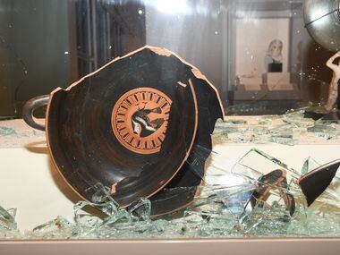 The outside of this kylix, the standard Greek vessel for wine drinking, features Hercules...