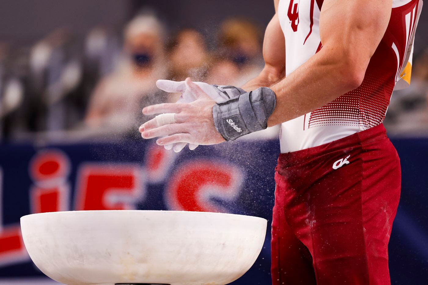 University of Oklahoma's Allan Bower chalks his hands before performing on the pommel horse during Day 1 of the US gymnastics championships on Thursday, June 3, 2021, at Dickies Arena in Fort Worth. (Juan Figueroa/The Dallas Morning News)
