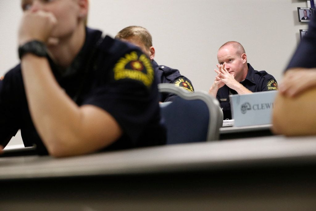 Daniel Bless listens as Deputy Chief Jeffrey Cotner teaches an excellence in policing class...
