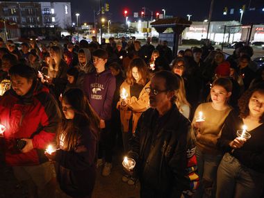 Community members and Paschal High School students gather during a candlelight vigil for...