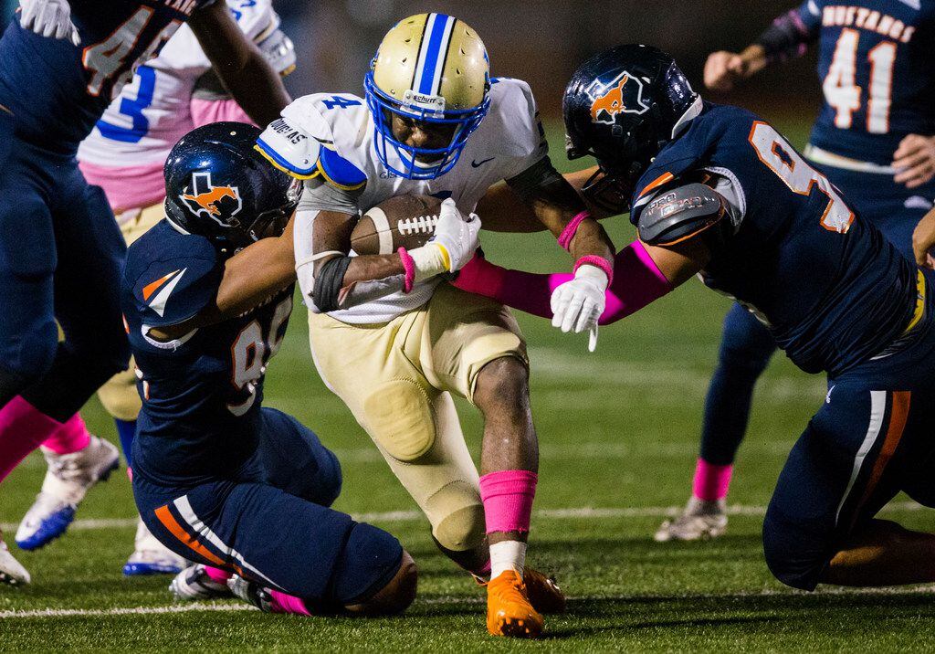 Garland Lakeview running back Camar Wheaton (4) is tackled by Sachse defensive linemen Ryan...