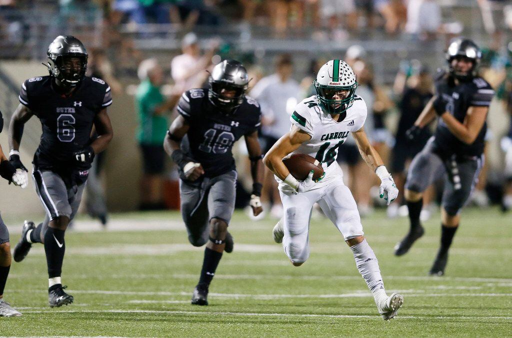 Southlake Carroll's Brady Boyd (14) runs up the field after the catch as Denton Guyer's Jonathan Jones (18) closes in on the play during the first half of play at C.H. Collins Complex in Denton, on Friday, October 4, 2019. (Vernon Bryant/The Dallas Morning News)