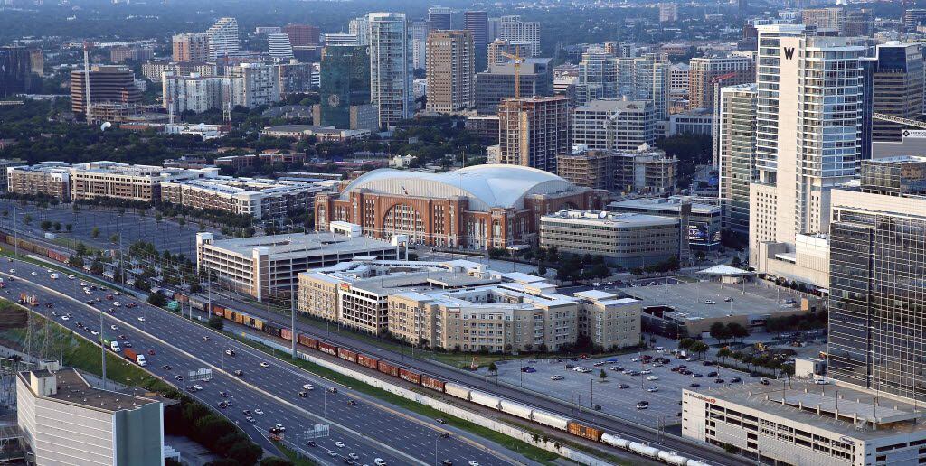An aerial shot of American Airlines Center surrounded by condominiums along I-35E in Dallas,...