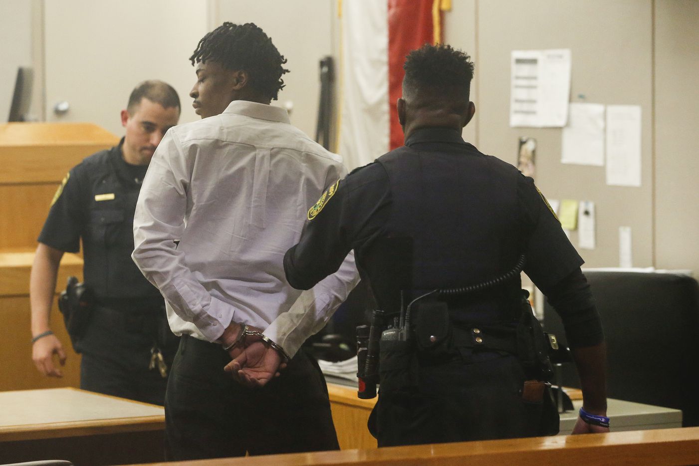 Desmond Jones stands as he is sentenced to 99 years in prison for engaging in organized criminal activity. (Ryan Michalesko/The Dallas Morning News)