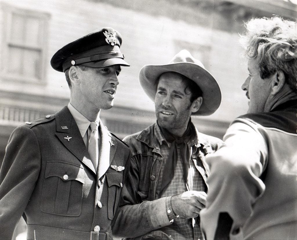 Before deploying overseas in World War II, James Stewart visited his friend Henry Fonda on the set of The Ox-Bow Incident. They are photographed speaking with director William Wellman. 