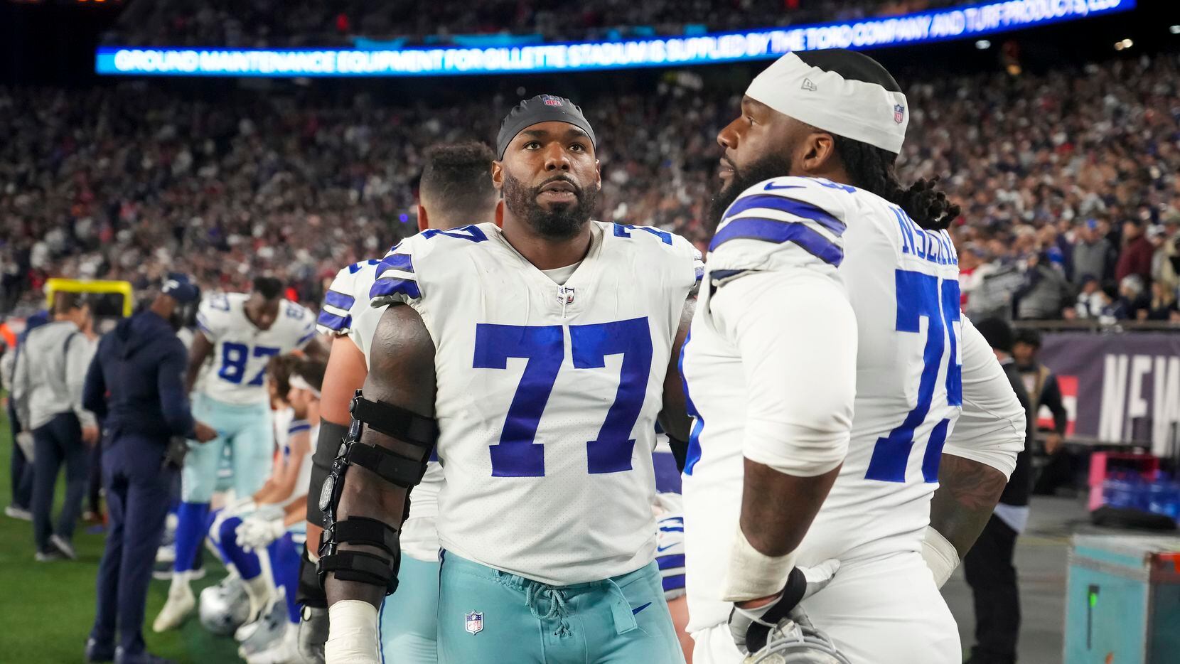 Dallas Cowboys offensive tackle Tyron Smith (77) looks up at the scoreboard as he stands on...