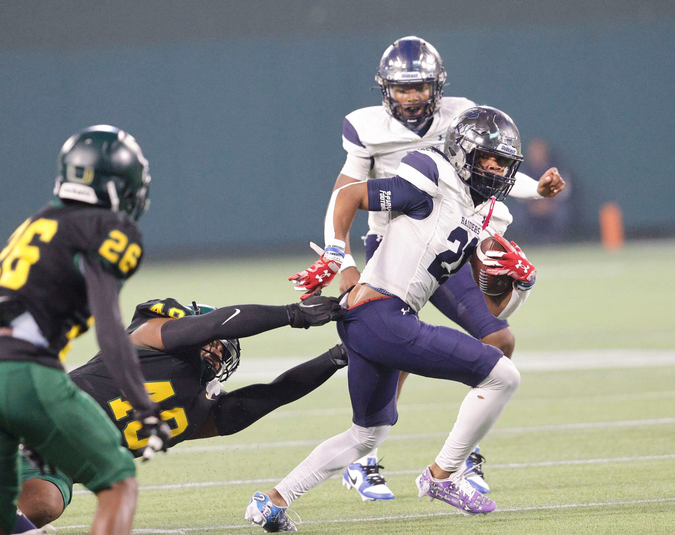 Wylie East's Michael Henderson (21) is tackled by DeSoto's Jason Douglas (48) during the...