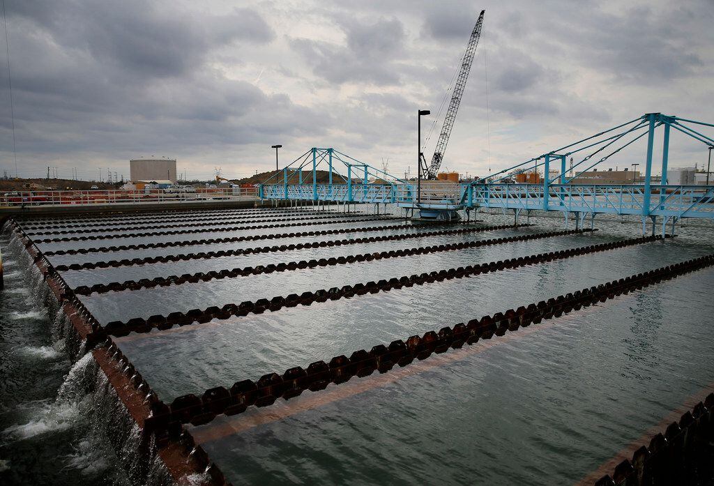As construction continues in Plant 3, water flows through a sedimentation basin at the North...