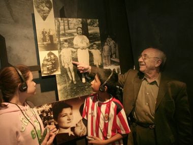 Max Glauben points to himself in a family photo before the war as he stands with Little Elm Lakeside Jr. High seventh-graders Anastasia Seis and Victor Rodriguez at The Dallas Holocaust Museum.