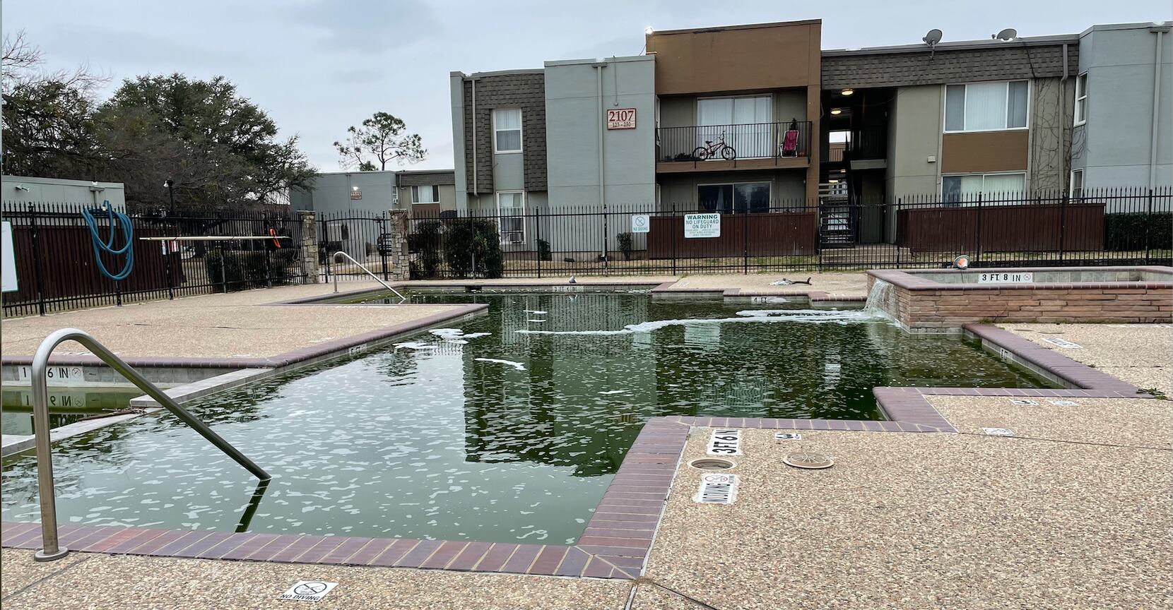 Green pool water is visible at Hillcrest Apartments in Mesquite, Texas on February 26, 2022....