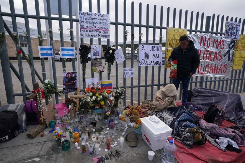 An altar with candles and photos covered the fence outside the Mexican immigration detention...