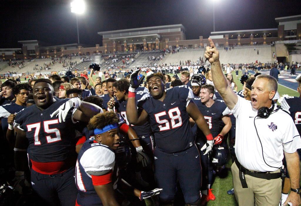 Allen offensive lineman E.J. Ndoma-Ogar (75) and linebacker Tai Brooks (58) dance while head coach Terry Gambill hoists his finger up after Allen High School got their first victory 23-8 as Allen High School hosted Cedar Hill High School in a football game at Eagle Stadium on Friday night, September 1, 2017. (Stewart F. House/Special Contributor)