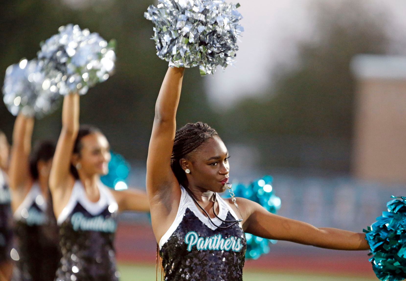 Frisco Panther Creek drill team members perform before the start of the first half of a high...