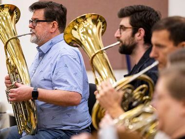 Musicians playing the Wagner tuba perform during the orchestral rehearsal for Dallas Opera’s...