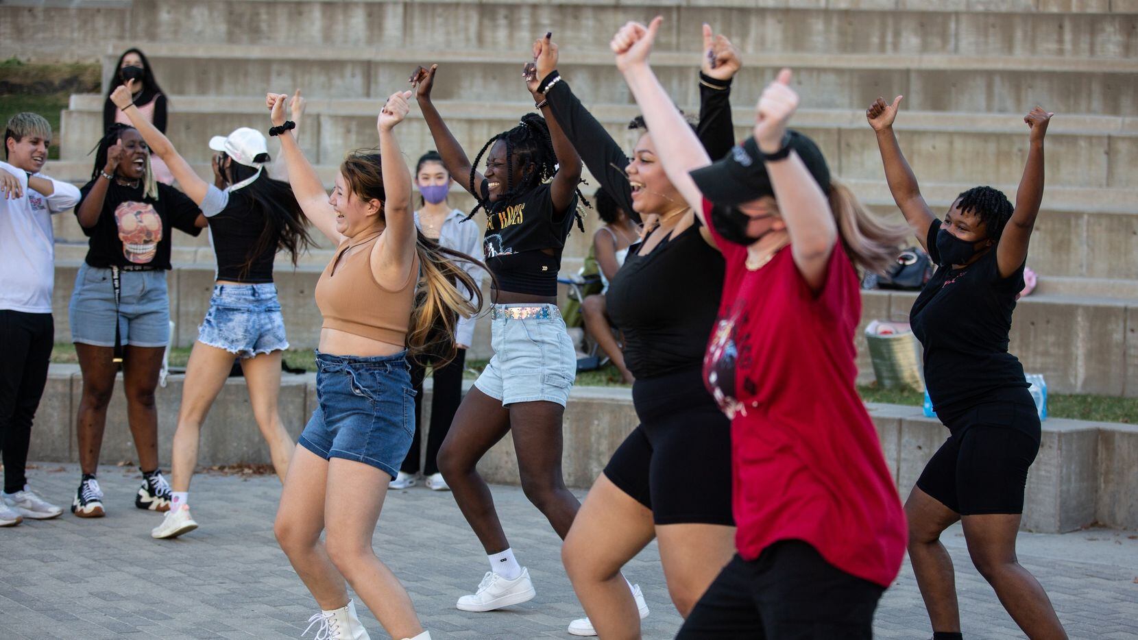 K-pop fans dance during a random dance play at a meetup organized by AEON, a Texas-based...