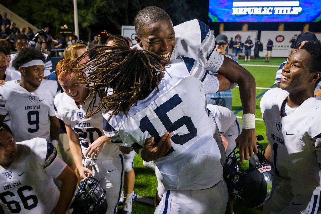 Frisco Lone Star safety Toren Pittman (15) lifts up wide receiver Marvin Mims (18) as they...