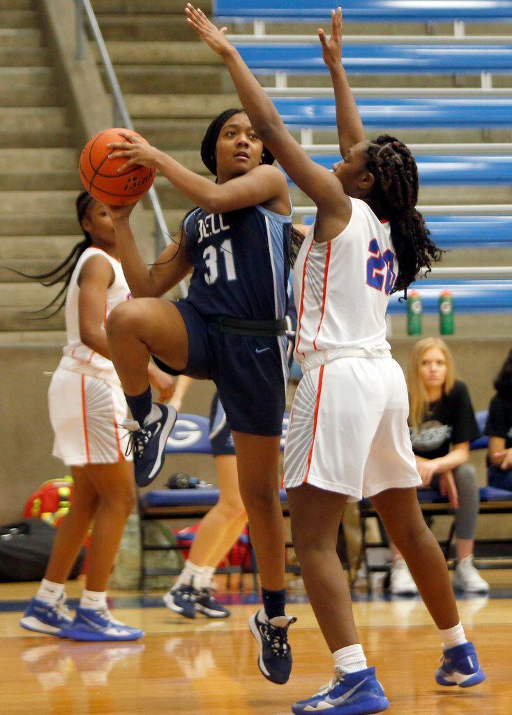 Hurst L.D. Bell guard Madison Gardner (31) looks to shoot as she is defended by Arlington...
