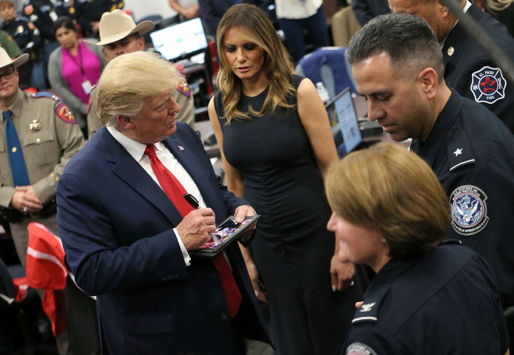 President Donald Trump signs autographs for first responders of Saturday's mass shooting  Aug. 7, 2019, at the Office of Emergency Management in El Paso, which he visited with first lady Melania Trump..