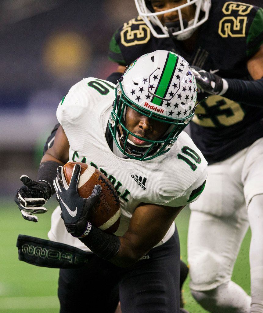 Southlake Carroll's RJ Mickens (10) catches a pass ahead of DeSoto defensive back Timmie...