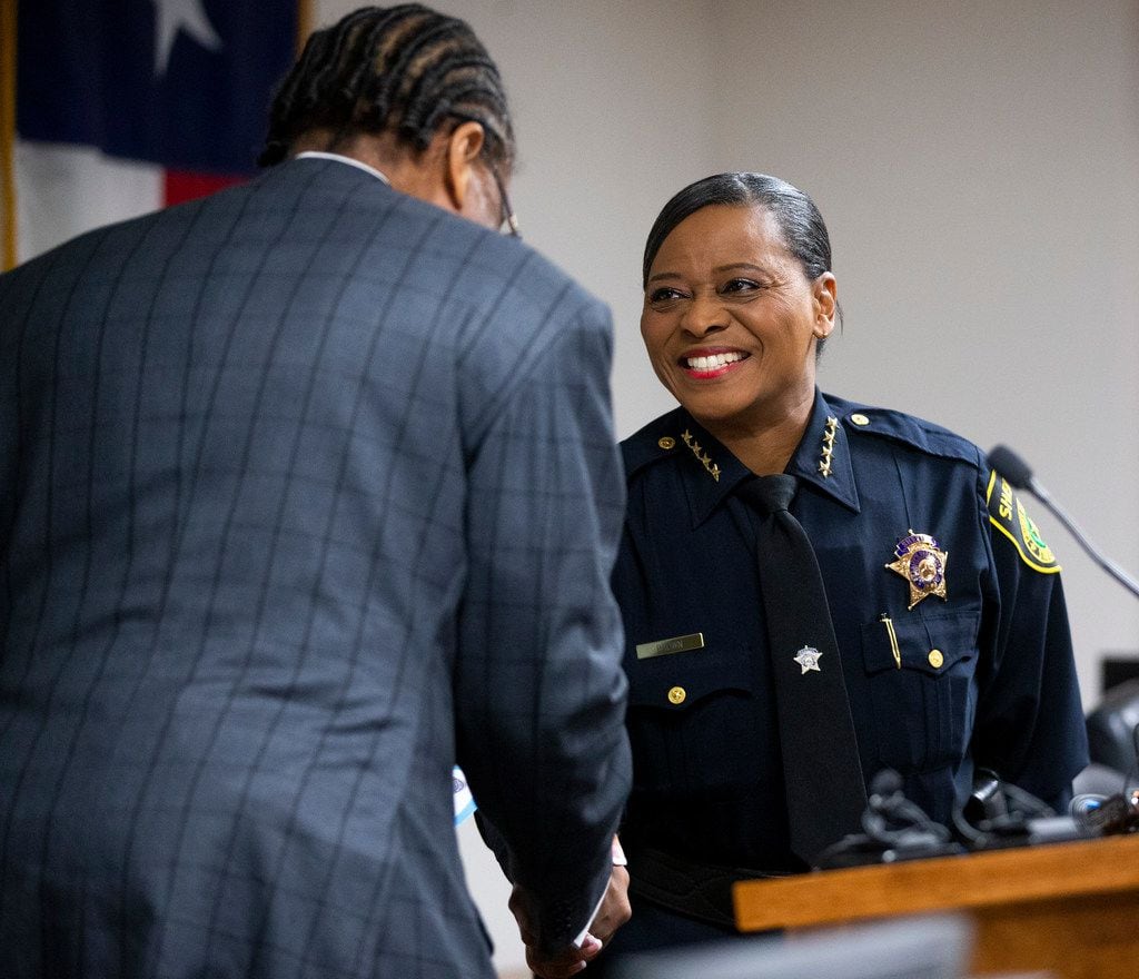 Dallas County Commissioner John Wiley Price shakes hands with Sheriff Marian Brown after...