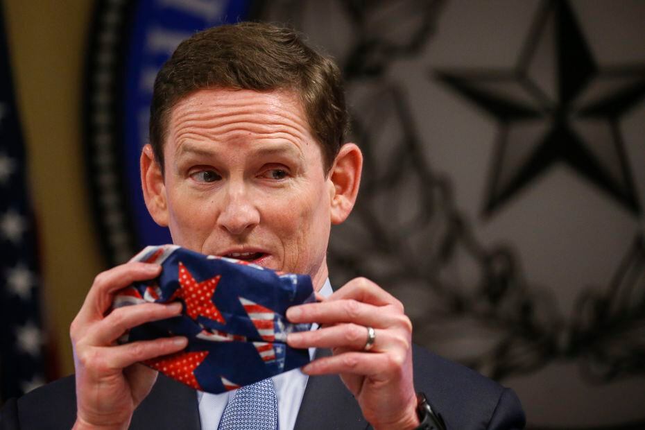 Dallas County Judge Clay Jenkins displays an improvised clothe face mask made with a bandana and hair ties as he addresses members of the media regarding the new coronavirus pandemic on Wednesday, April 8, 2020 at the Dallas County Emergency Operations Center in Dallas. (Ryan Michalesko/Staff Photographer)