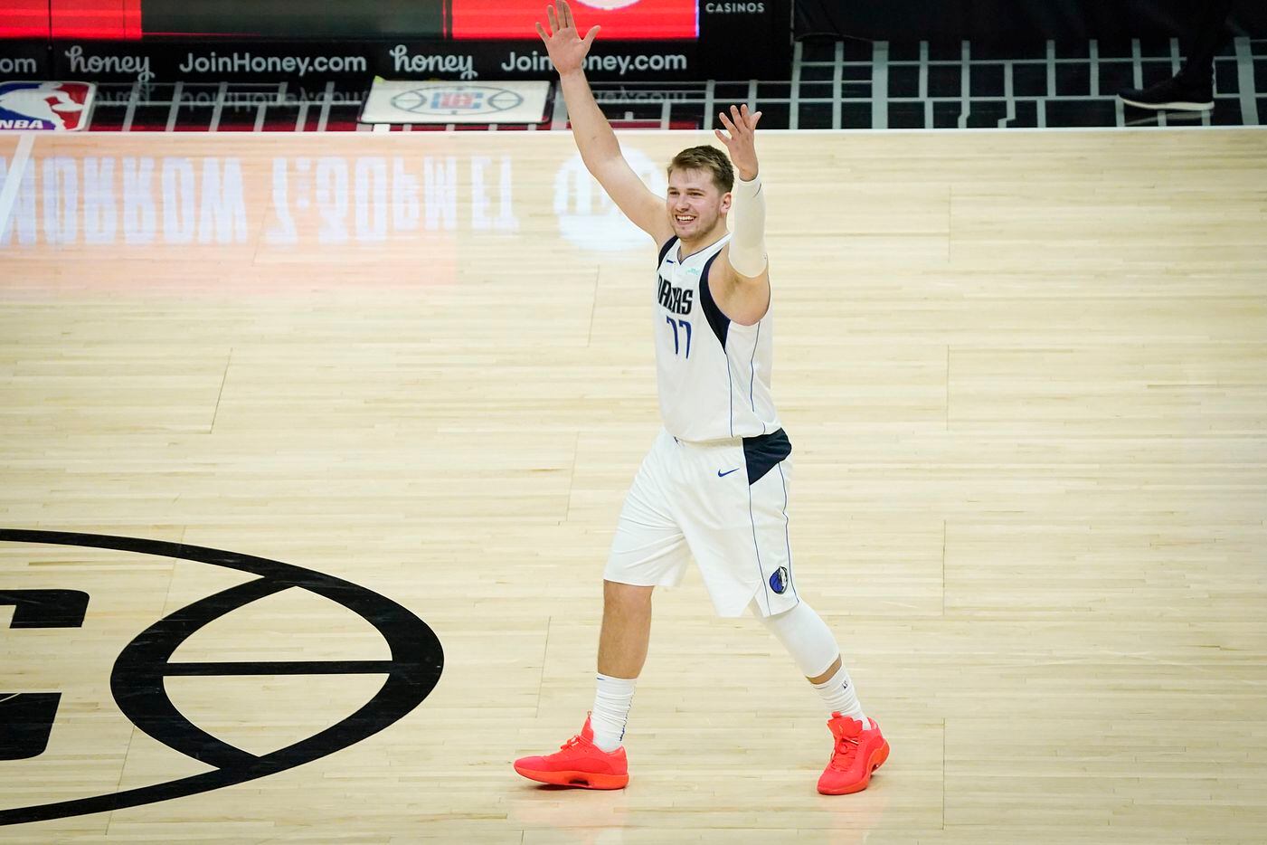 Dallas Mavericks guard Luka Doncic (77) celebrates a 3-pointer by forward Tim Hardaway Jr. during the second half of an NBA playoff basketball game against the LA Clippers at Staples Center on Tuesday, May 25, 2021, in Los Angeles. The Mavericks won the game 127-121.