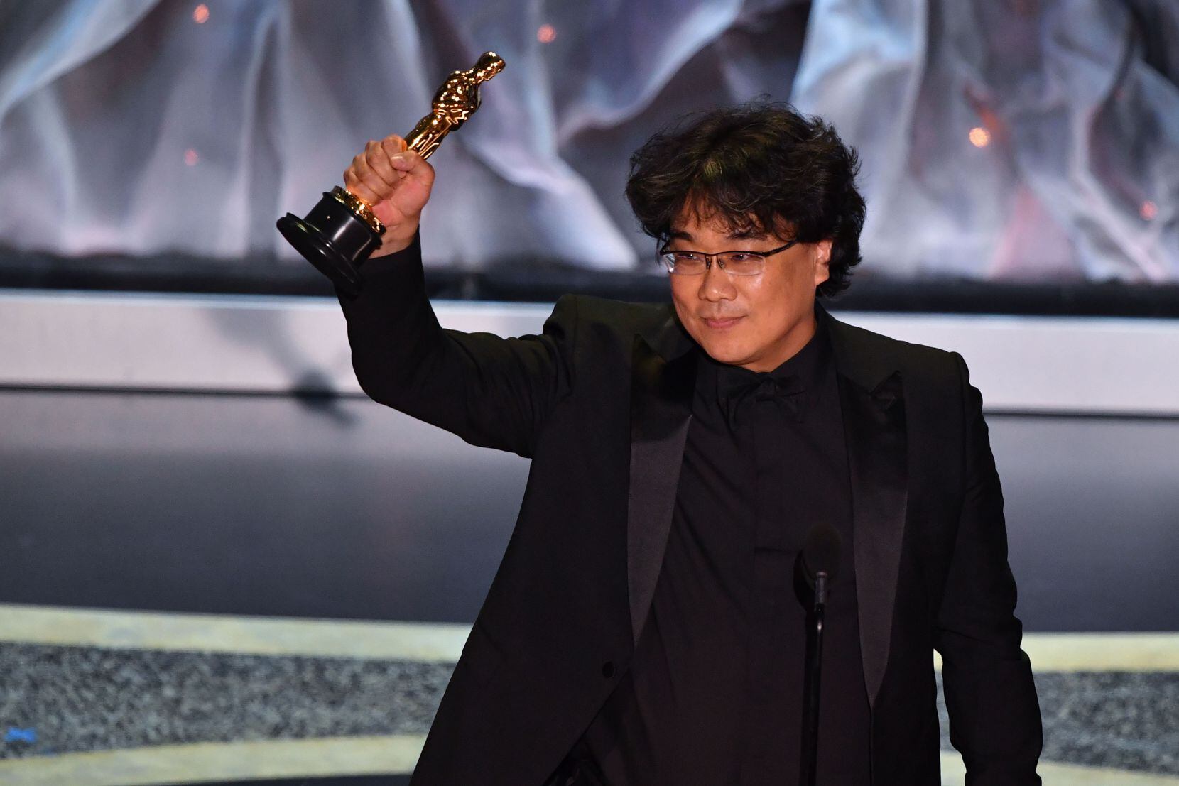 South Korean director Bong Joon-ho accepts the award for Best International Feature Film for "Parasite" during the 92nd Oscars at the Dolby Theatre in Hollywood, California on Feb. 9, 2020.