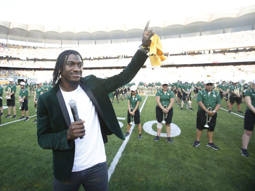 Former Baylor Bears quarterback Robert Griffin III acknowledges the crowd before the start of the inaugural game between Baylor University and Southern Methodist University at McLane Stadium in Waco on Sunday, August 31, 2014.