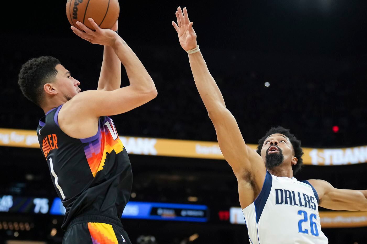 Phoenix Suns guard Devin Booker (1) shoots over Dallas Mavericks guard Spencer Dinwiddie...