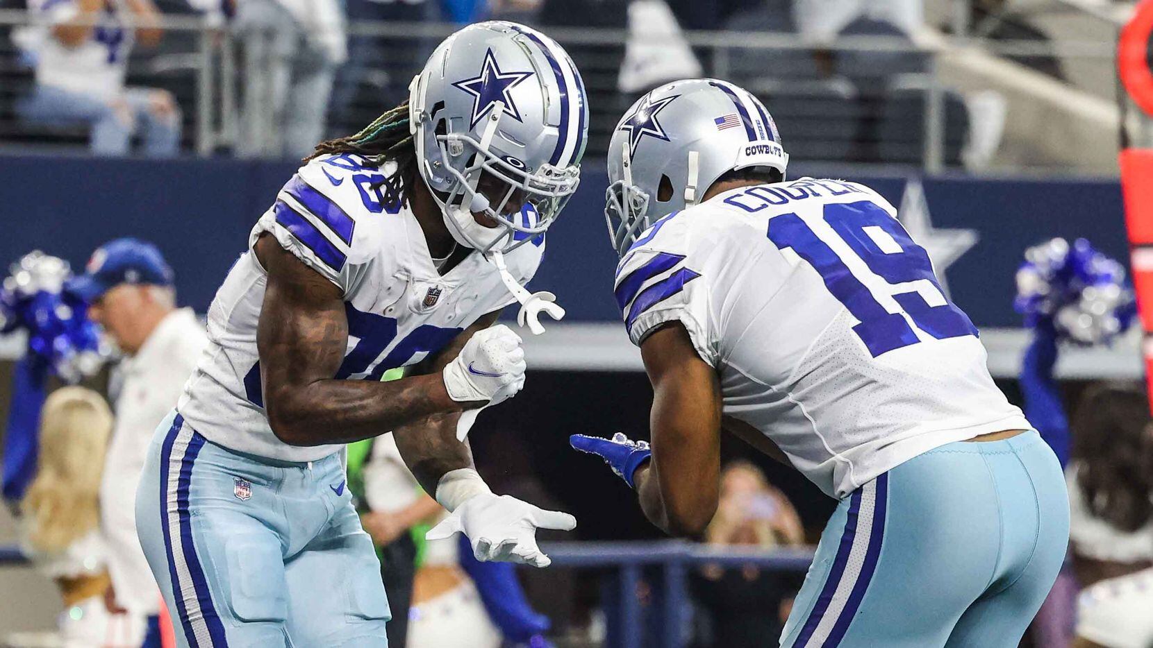 Dallas Cowboys' CeeDee Lamb (88) and Amari Cooper (19) celebrate a touchdown during the...