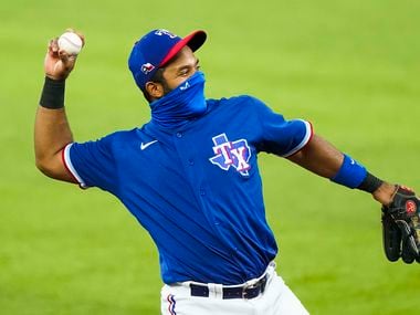 Texas Rangers shortstop Elvis Andrus wears a face mask as warms up before an exhibition game against the Colorado Rockies at Globe Life Field on Tuesday, July 21, 2020.